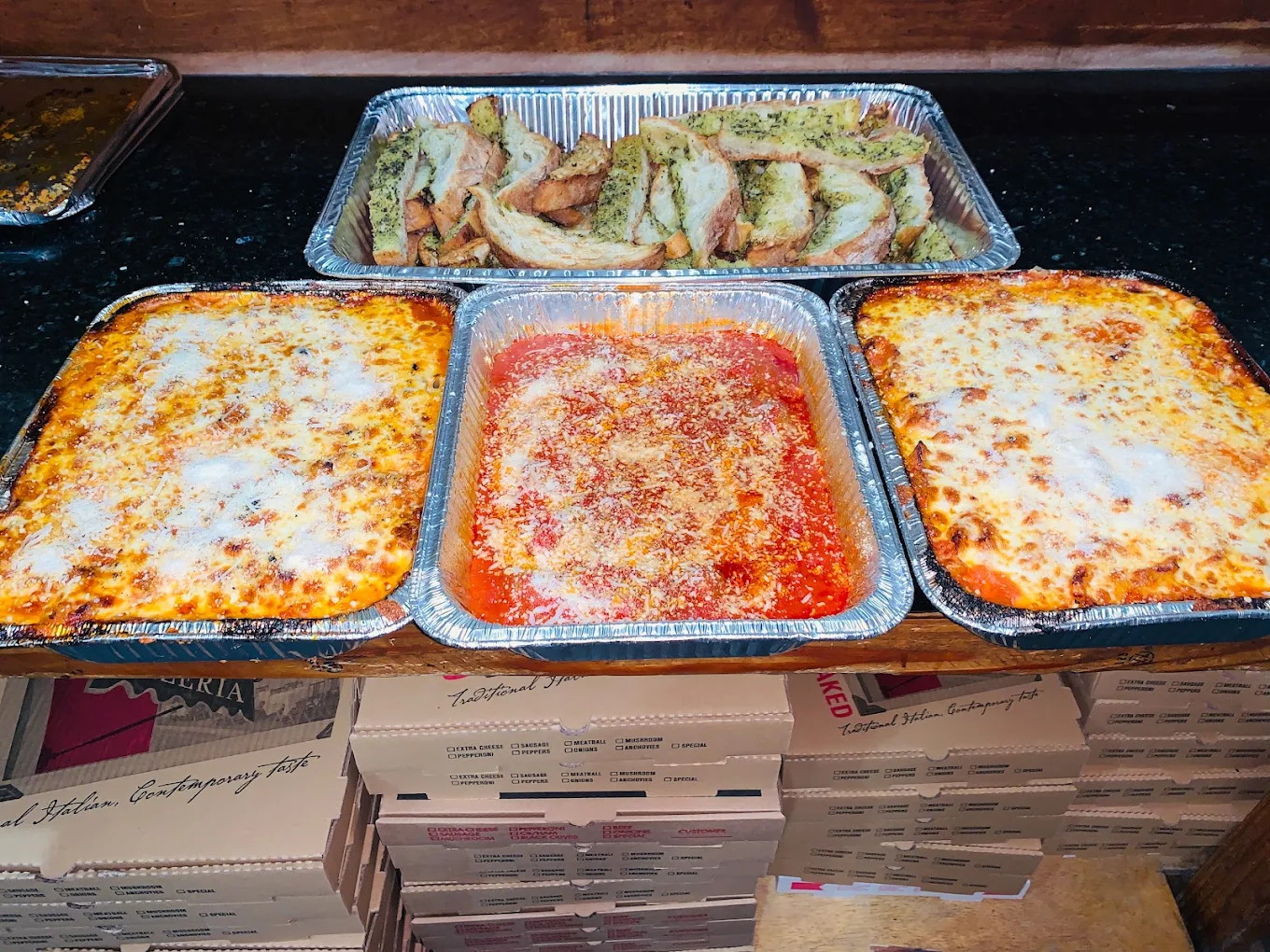Catering trays of lasagna with garlic bread