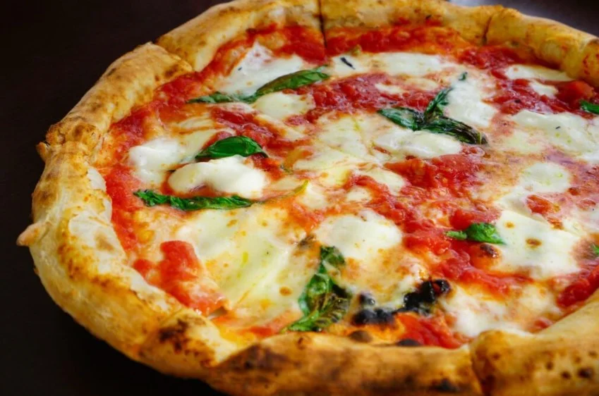Classic Margherita pizza with bubbly crust and fresh basil