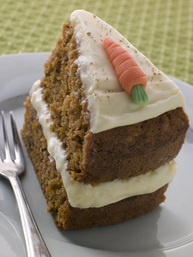Slice of carrot cake with cream cheese frosting