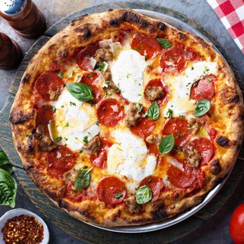 Pepperoni, sausage, and ricotta pizza with basil