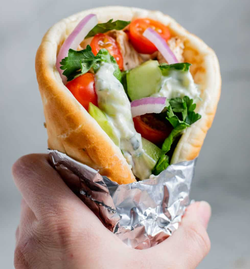 Greek gyro wrap with tzatziki, tomatoes, and red onion
