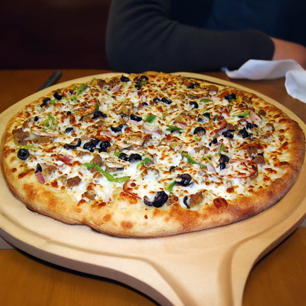 Supreme pizza on a wooden serving board