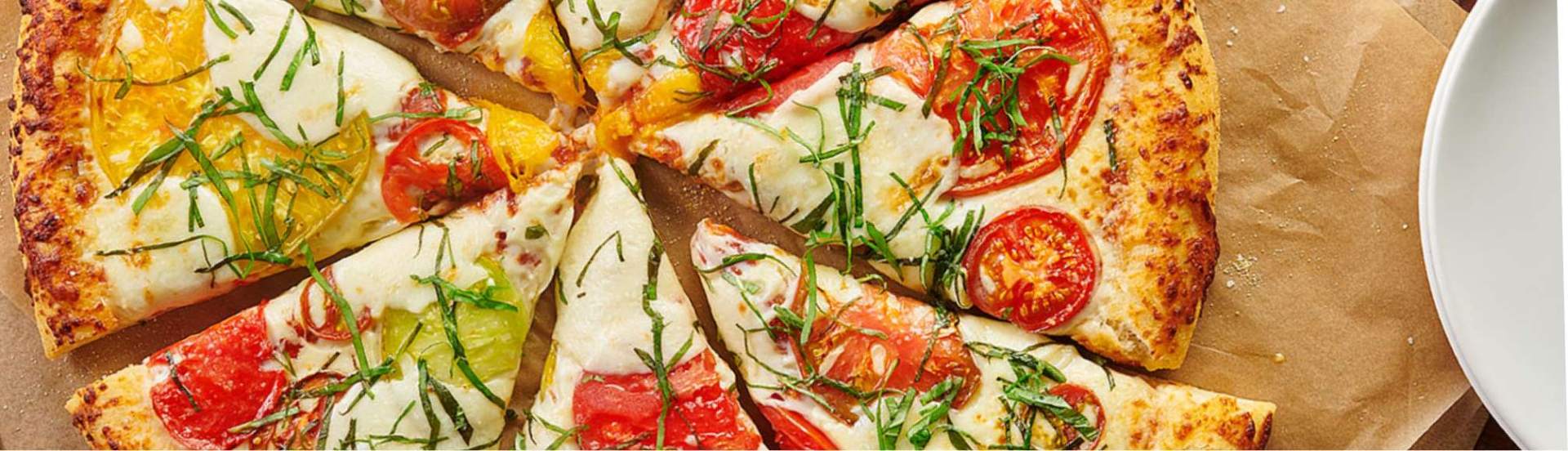 Heirloom tomato pizza with fresh basil ribbons