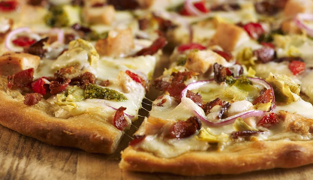 Artichoke flatbread pizza with bacon and red onion