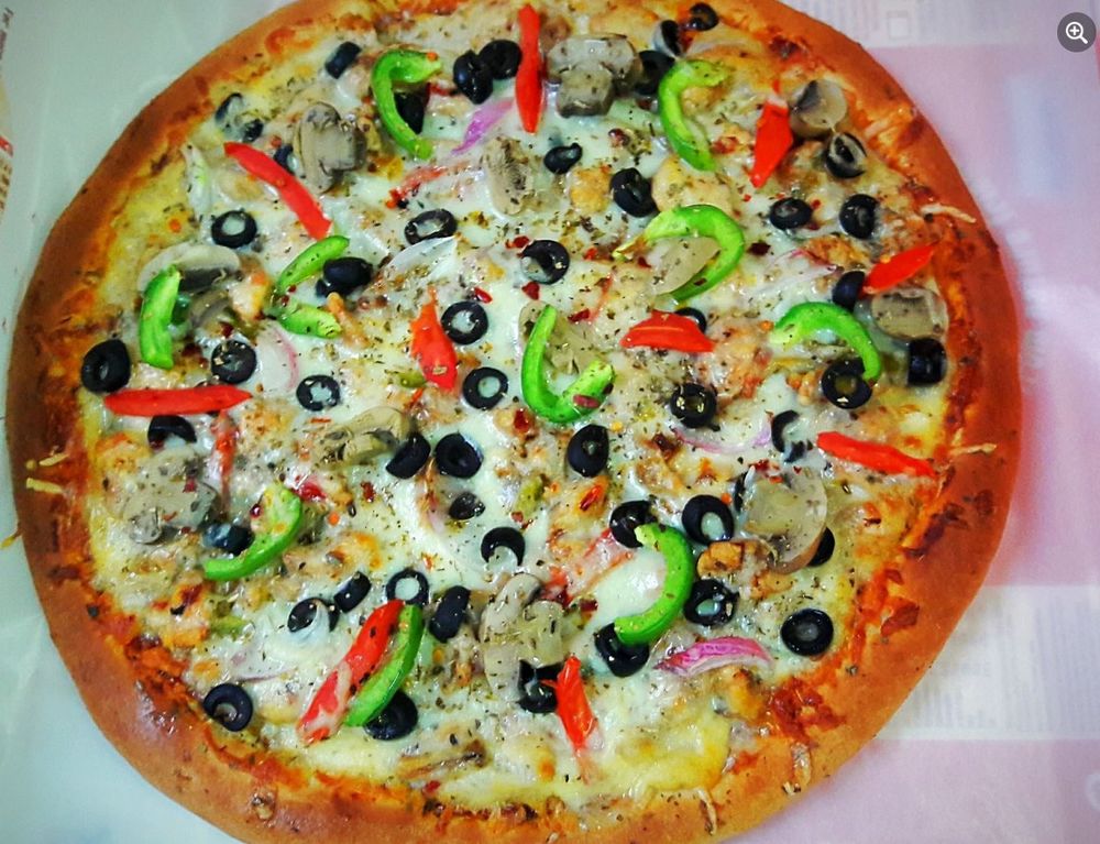 Veggie supreme pizza with olives, peppers, and mushrooms