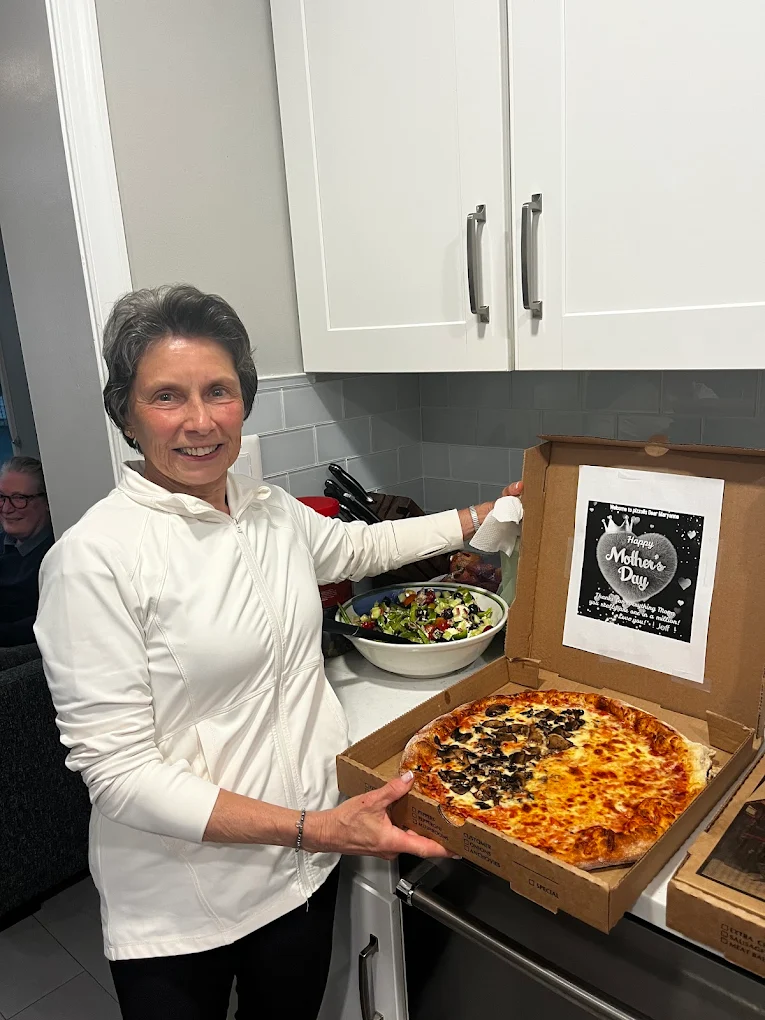 Happy customer with a Mother's Day pizza