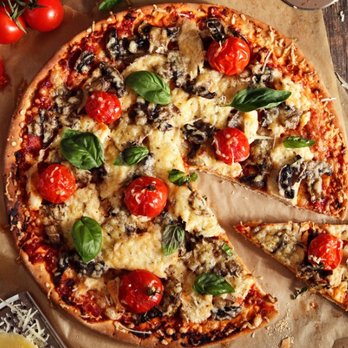 Mushroom and cherry tomato pizza with fresh basil